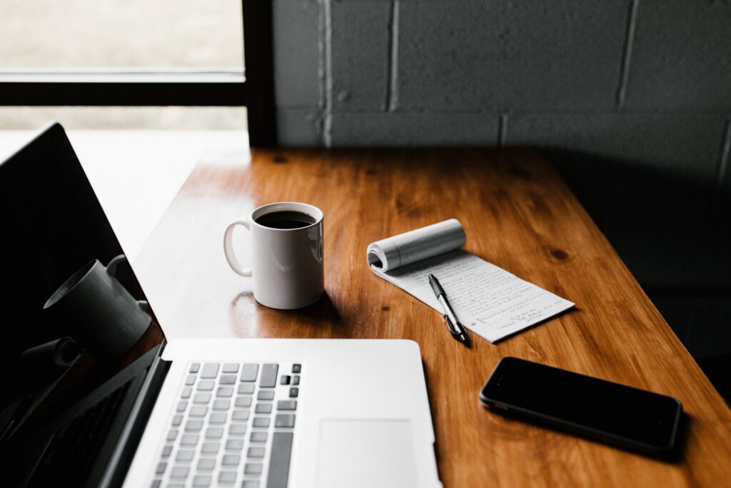 Entrepreneur laptop on desk with coffee and phone
